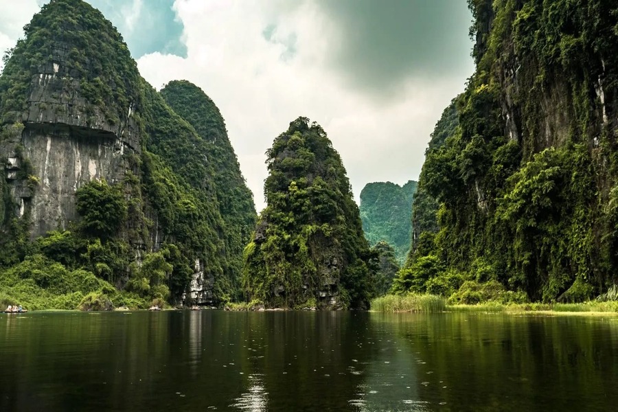 Boats cruising among limestone islands in Halong Bay on trips to Vietnam and Cambodia